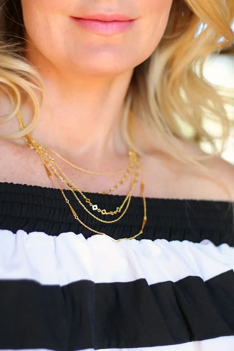 erin busbee of busbeestyle wearing an MLM label off shoulder top and skinny cropped jeans by citizens of humanity with gorjana necklace