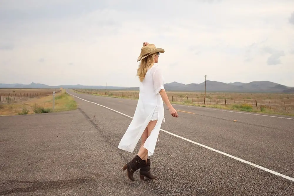 maxi shirt, denim cutoff shorts by BLANK NYC, cowboy hat and white tank with brown buckle moto boots