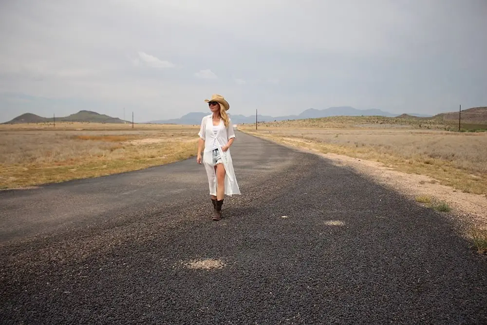 maxi shirt from Asos, denim cutoff shorts by BLANK NYC, cowboy hat and white tank with brown buckle moto boots