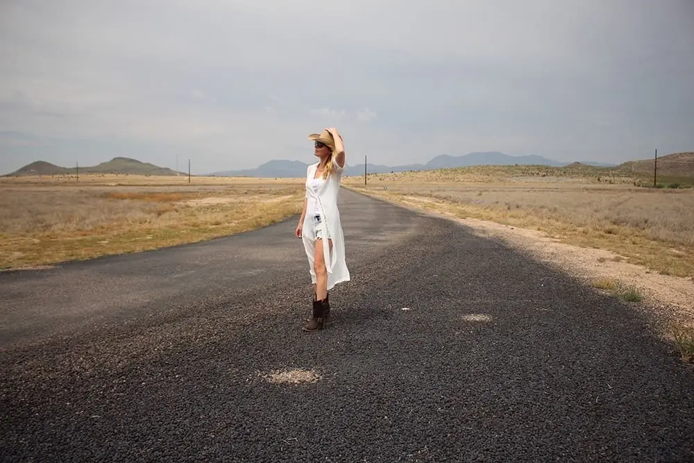 maxi shirt from Asos, denim cutoff shorts by BLANK NYC, cowboy hat and white tank with brown buckle moto boots