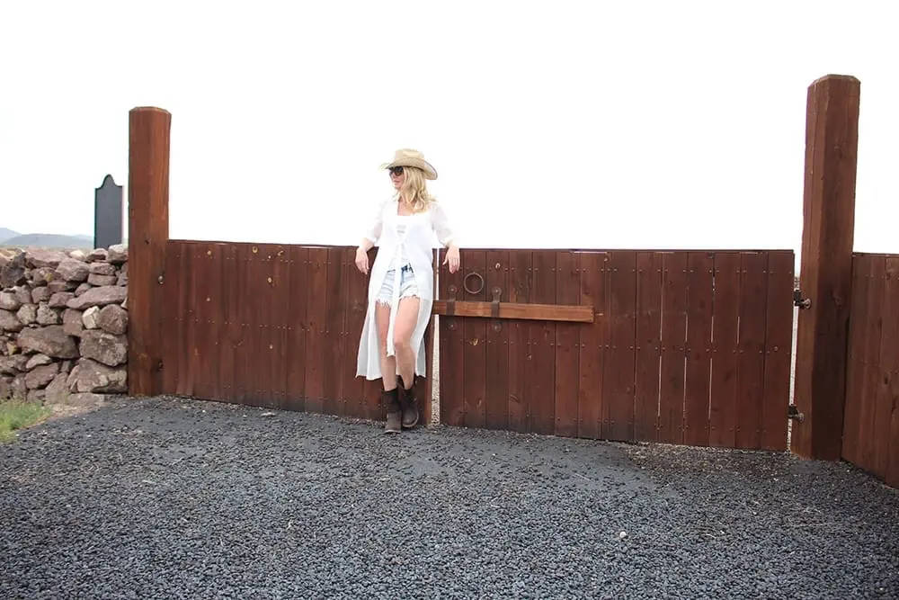 maxi shirt from Asos, denim cutoff shorts by BLANK NYC, cowboy hat and white tank with brown buckle moto boots