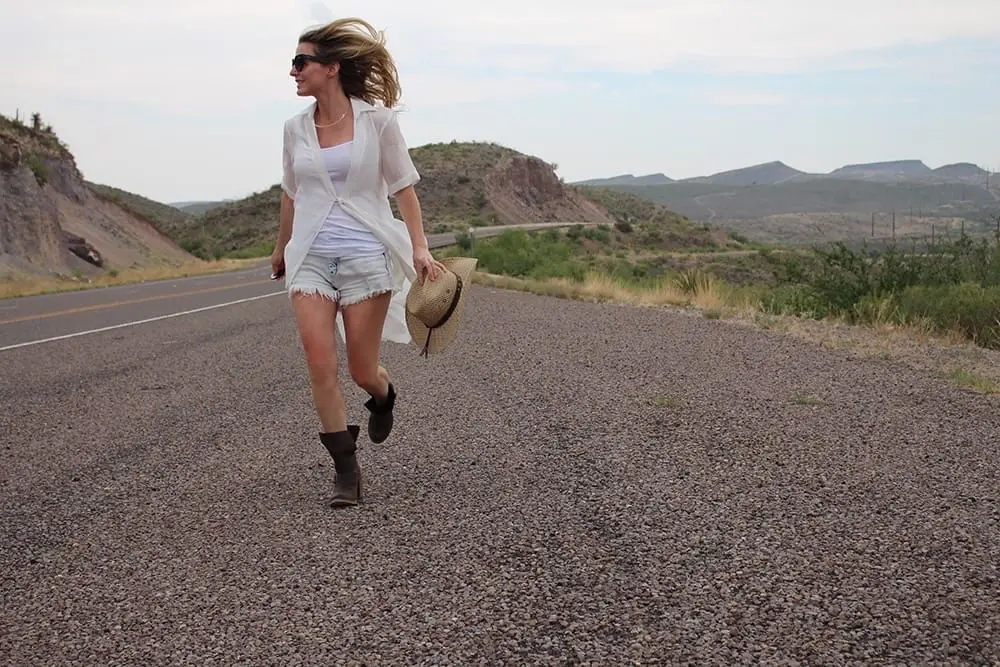 maxi shirt from Asos, denim cutoff shorts by BLANK NYC, cowboy hat and white tank with brown buckle moto boots
