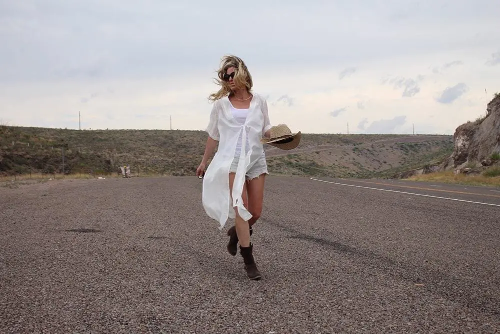 maxi shirt from Asos, denim cutoff shorts by BLANK NYC, cowboy hat and white tank with brown buckle moto boots