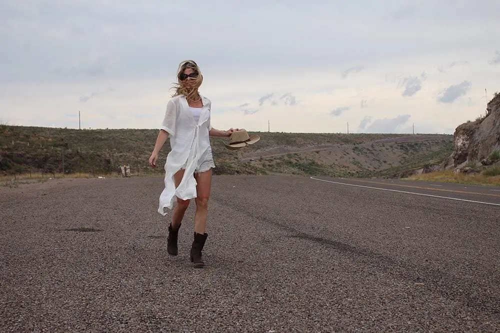maxi shirt from Asos, denim cutoff shorts by BLANK NYC, cowboy hat and white tank with brown buckle moto boots