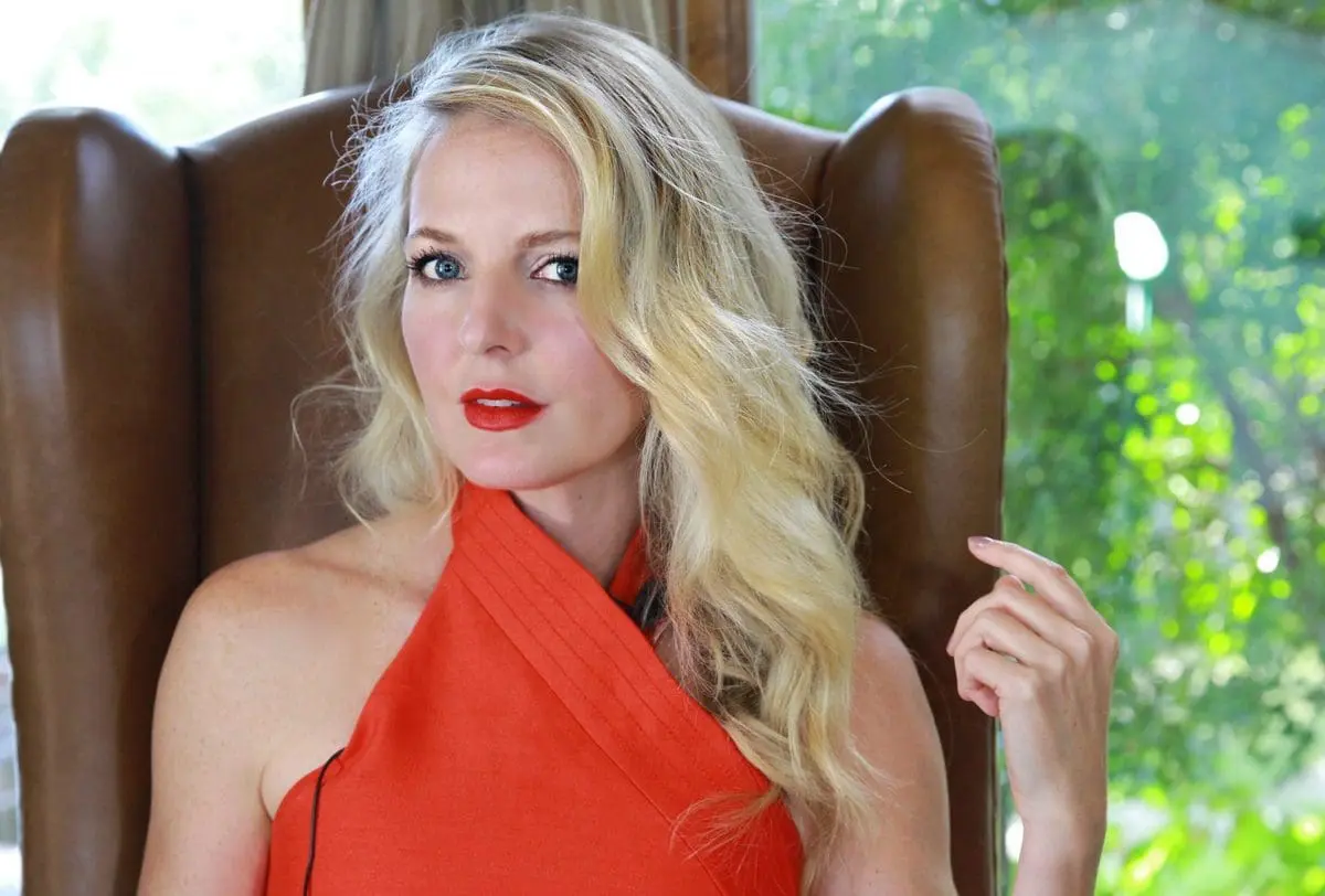 style expert erin busbee wearing a red c/meo collective halter top and red lipstick