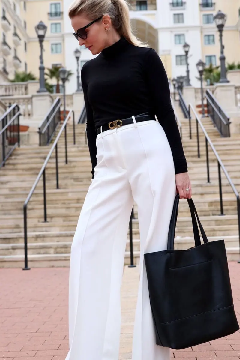 how to wear winter white, I show you three outfit options in this post including this look featuring a black classic turtleneck from nordstrom with a great black vegan affordable tote bag by sole society