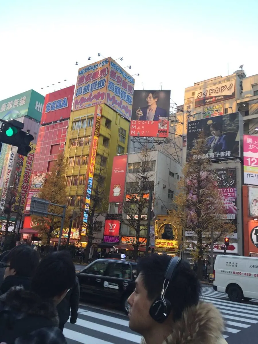 walking through the streets of tokyo japan on a family vacation looking at all the city lights and modern buildings