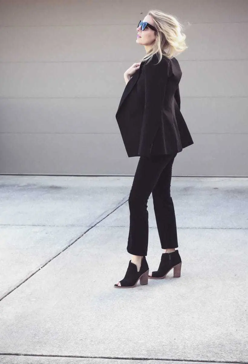 Erin Busbee, fashion blogger and wardrobe stylist from Busbee Style is wearing a Baublebar lariat choker necklace in black paired with a veronica beard scuba blazer and cropped, flared pants by Rag and Bone with Vince Camuto peep toe booties in black. Wear all one color to look longer and taller