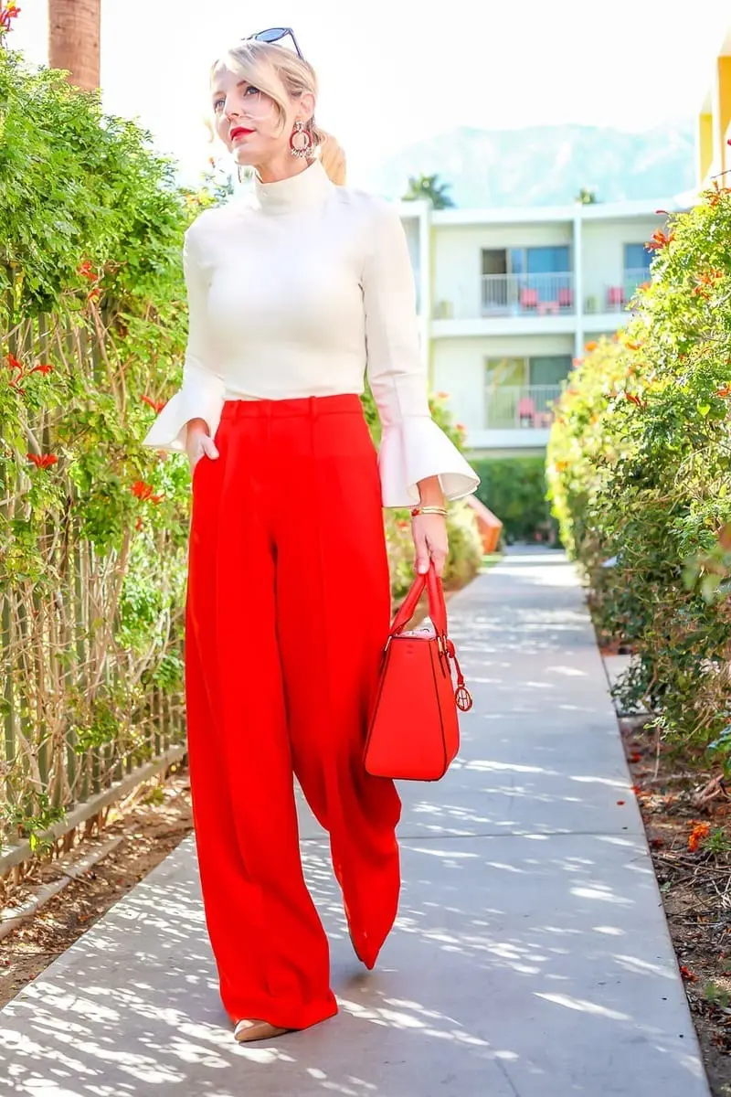 Bright pants are by BCBG. These high waist, wide leg trousers will make a big statement the matching red bag by Henri Bendel finishes off the look!