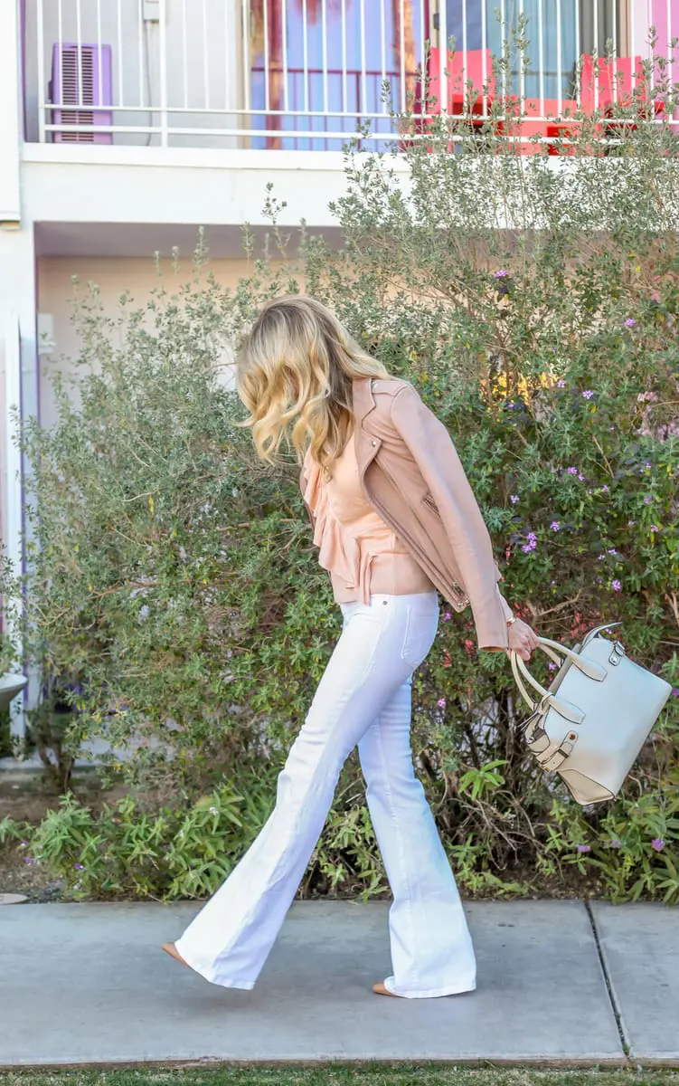 erin busbee from busbeestyle.com in palm springs for alt summit wearing wide leg white jeans, a ruffle peach sweater by topshop and an iro jacket called "Han" in taupe carrying a Henri Bendel handbag in sea salt white