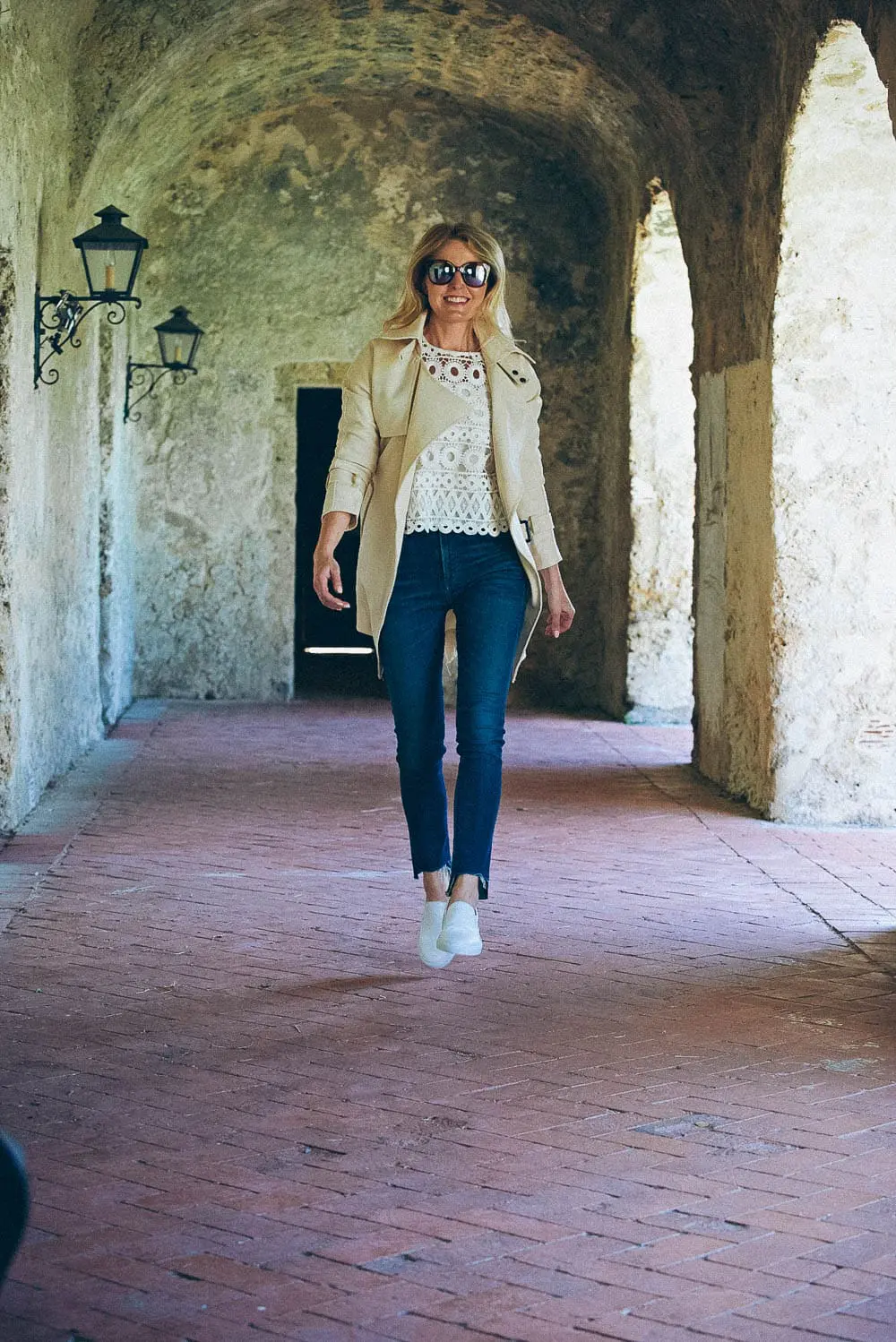 White sneakers slip on by Greats brand, worn 2 ways, including jeans and a one-shoulder top and a beige trench and white eyelet top, featured on Erin Busbee, of BusbeeStyle, fashion blogger and youtuber