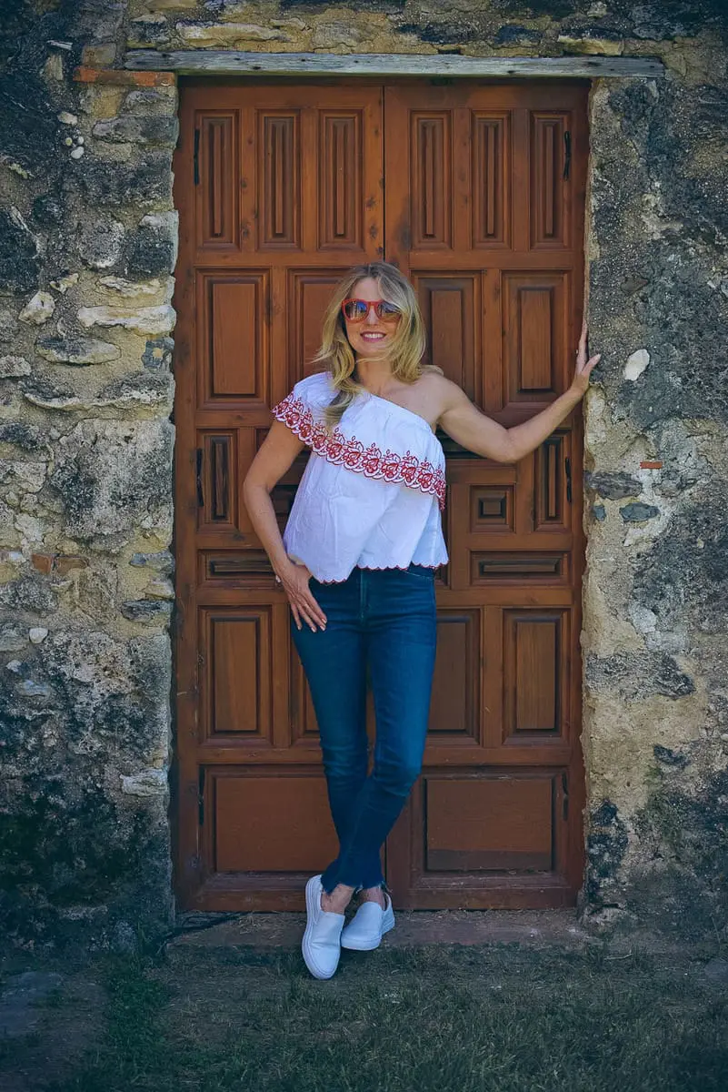 White sneakers slip on by Greats brand, worn 2 ways, including jeans and a one-shoulder top and a beige trench and white eyelet top, featured on Erin Busbee, of BusbeeStyle, fashion blogger and youtuber