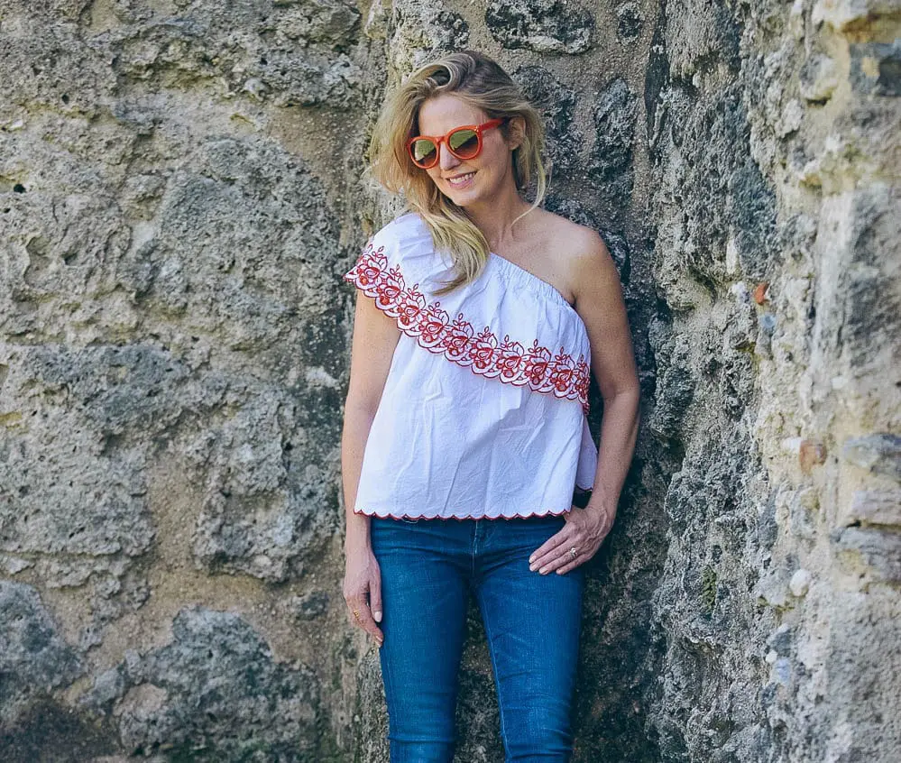 White sneakers slip on by Greats brand, worn 2 ways, including jeans and a one-shoulder top and a beige trench and white eyelet top, featured on Erin Busbee, of BusbeeStyle, fashion blogger and youtuber