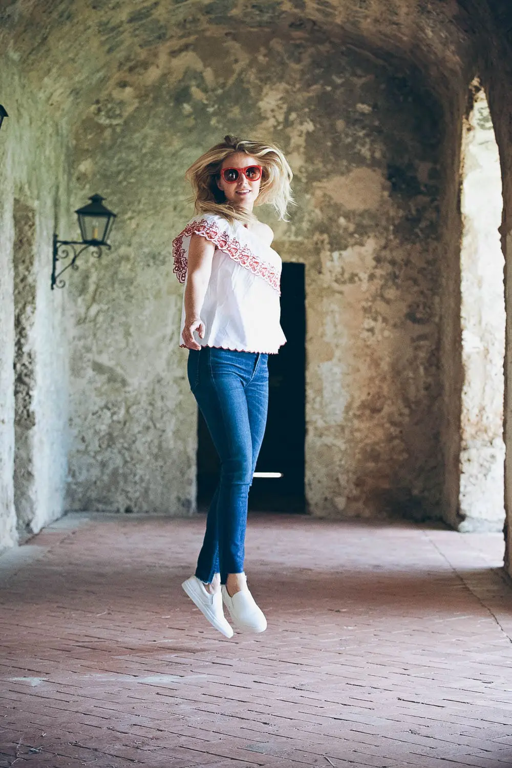 White sneakers slip on by Greats brand, worn 2 ways, including jeans and a one-shoulder top and a beige trench and white eyelet top, featured on Erin Busbee, of BusbeeStyle, fashion blogger and youtuber