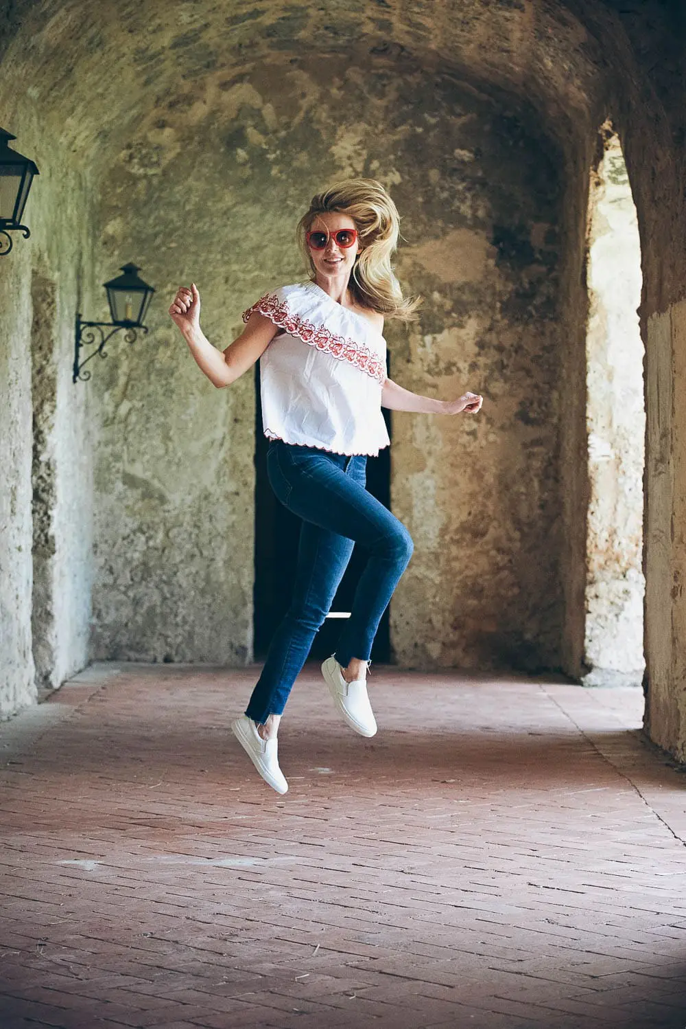 White sneakers slip on by Greats brand, worn 2 ways, including jeans and a one-shoulder top and a beige trench and white eyelet top, featured on Erin Busbee, of BusbeeStyle, fashion blogger and youtuber