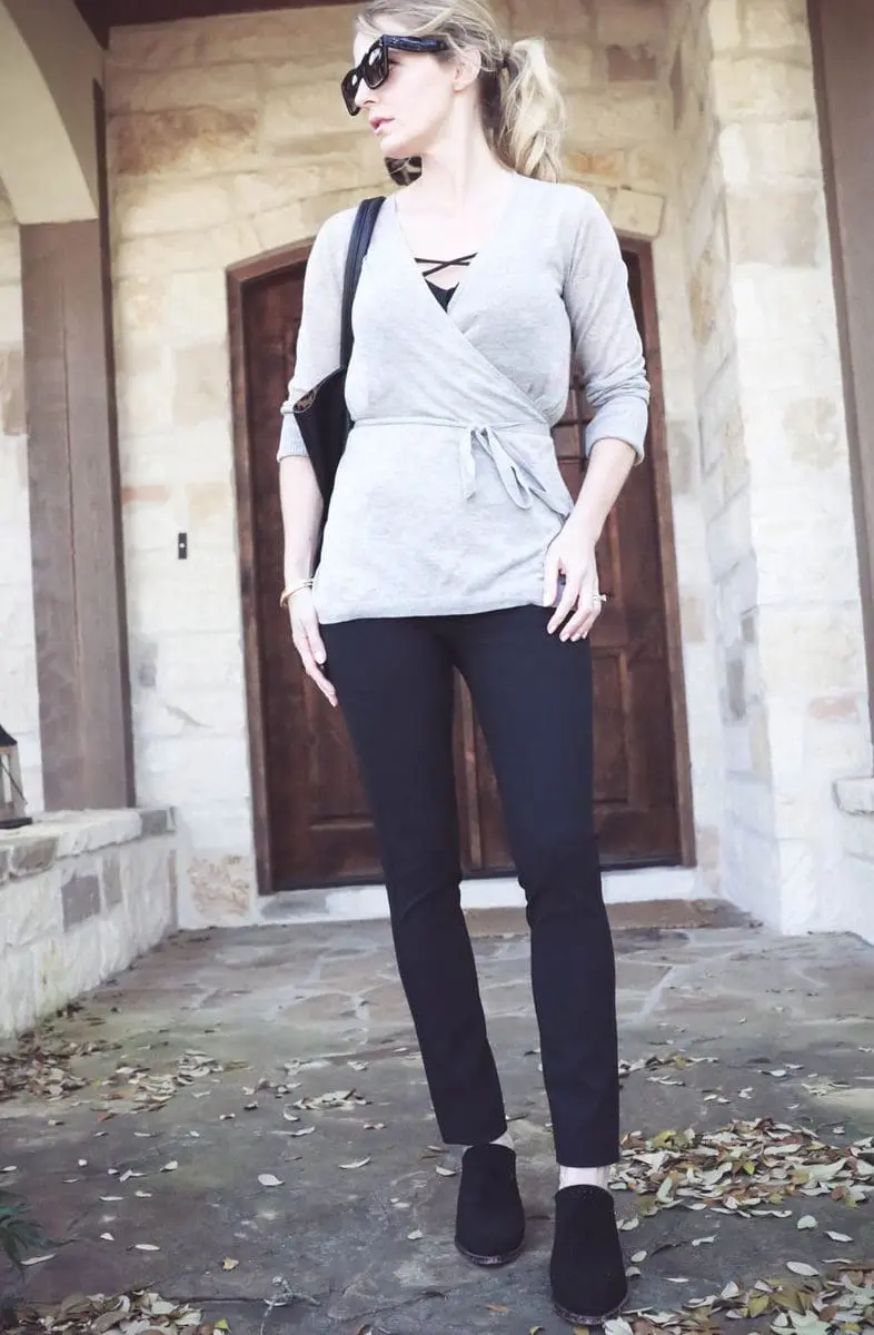 Erin Busbee wearing rag and bone slimone pants in black with a wrap sweater from Nordstrom and carrying sole society black tote vegan leather