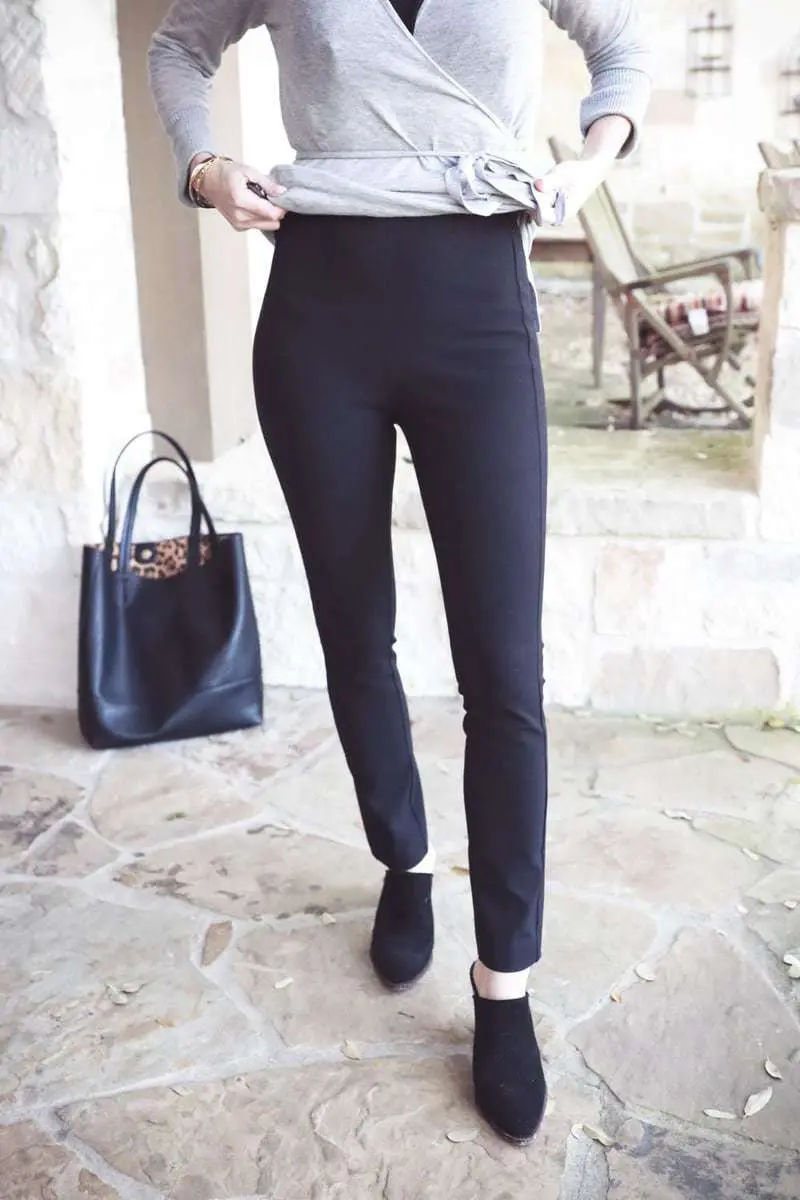 Erin Busbee wearing rag and bone slimone pants in black with a wrap sweater from Nordstrom and carrying sole society black tote vegan leather
