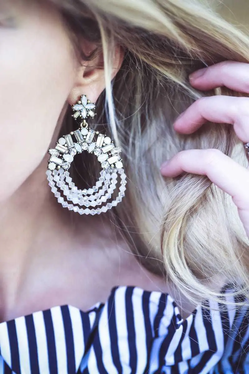 What I Wore video series by Erin Busbee, fashion blogger and youtuber for busy women over 40, featuring an off-shoulder, ruffle, striped top from Shein, a pair of moto skinny jeans by Lovers + Friends, and a pair of white pumps by Charles David shoes, and polar drop statement earrings by Baublebar