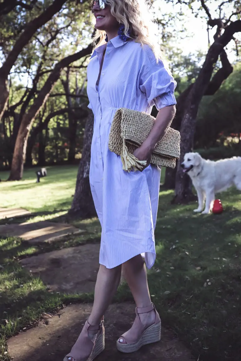 Banker striped dress in blue and white stripes, with cinched waist, and a straw tassel clutch from Ann Taylor, and marc fisher nude espadrilles on fashion blogger and youtuber Erin Busbee, BusbeeStyle.com