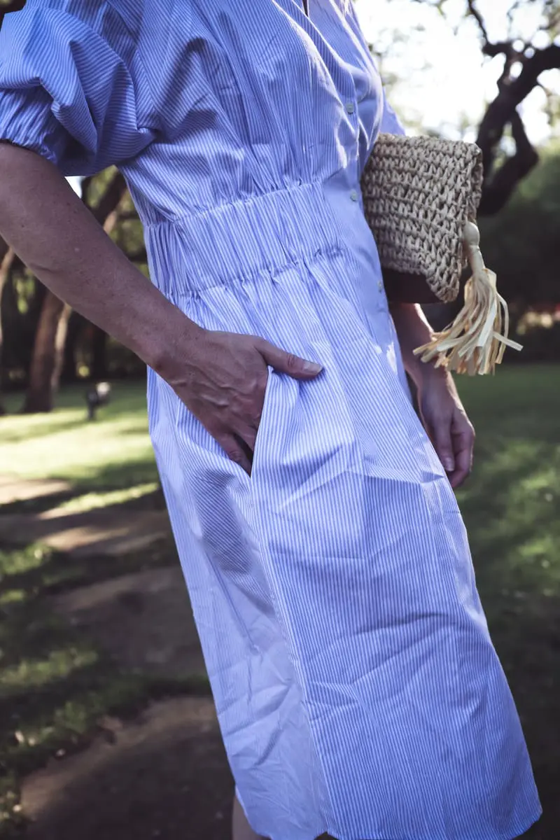 Blue and white striped shirt dress, Ann Taylor straw basket bag with tassel, and Marc Fisher nude wedges on erin busbee, of busbeestyle.com