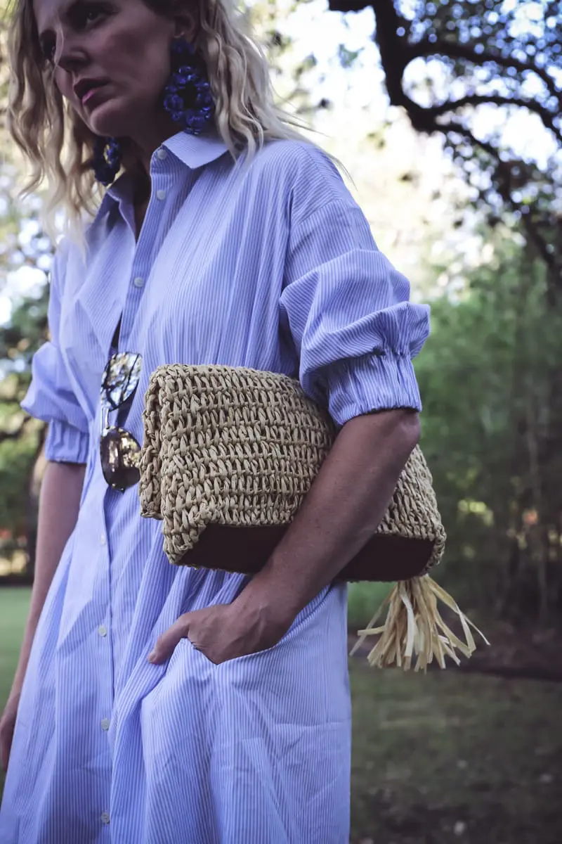 Banker striped dress in blue and white stripes, with cinched waist, and a straw tassel clutch from Ann Taylor, and marc fisher nude espadrilles on fashion blogger and youtuber Erin Busbee, BusbeeStyle.com