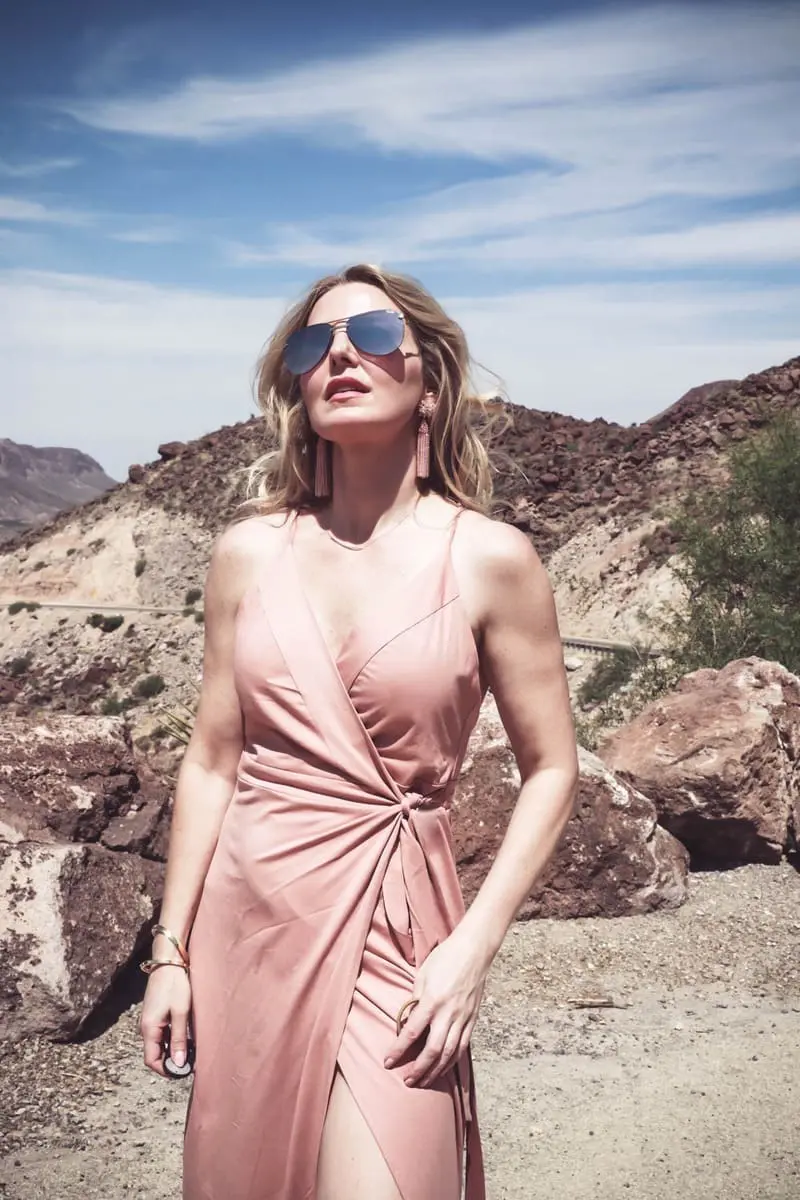 Wrap Dress by Wyldr from Asos and Revolve in blush nude color with Marc Fisher perforated ankle strap espadrilles wedges, on fashion blogger and fashion youtuber erin busbee of busbestyle, san antonio, texas, shot near Big Bend National Park in West Texas along the Rio Grande, with mirrored aviator sunglasses 