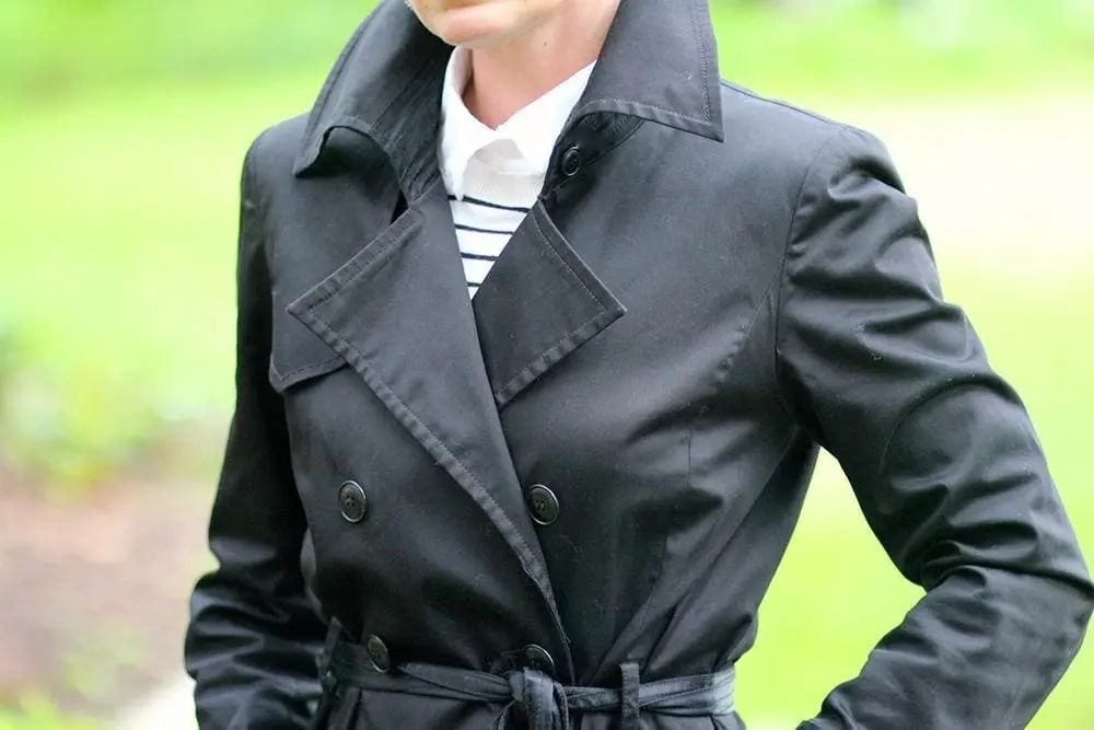 Rainy day must-haves, including a rain hat, an umbrella, trench coat, water resistant and waterproof rain boots