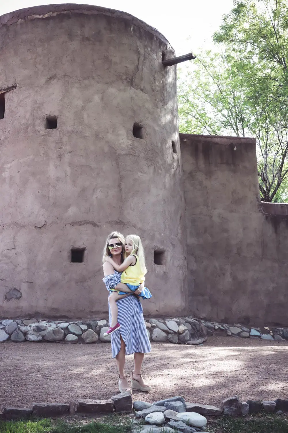 Fashion trends, cold shoulder, exposed shoulder, blue and white stripes, shirt dress by Bardot, sunglasses by Quay in silver aviator, and espadrille wedges in nude by Marc Fisher, at resort ranch in West Texas called Cibolo Creek