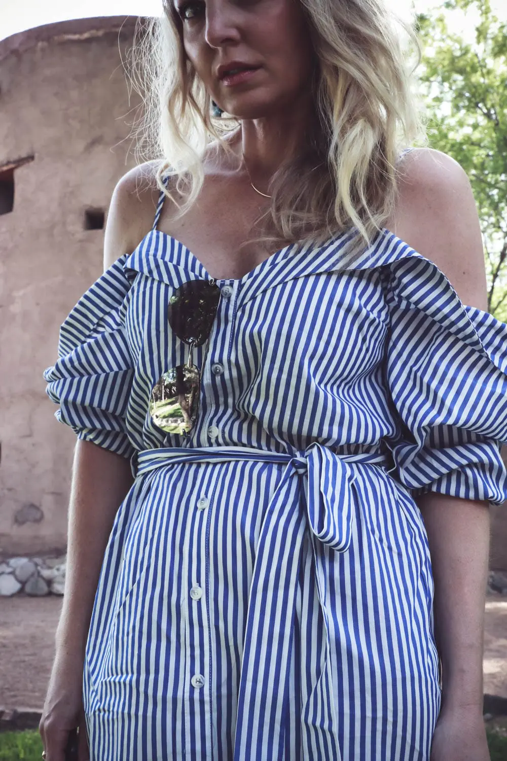 cold shoulder trend, exposed shoulder shirt dress by Bardot in blue and white stripes, paired with marc fisher wedges, quay mirrored sunglasses on fashion blogger and youtuber over 40, erin busbee