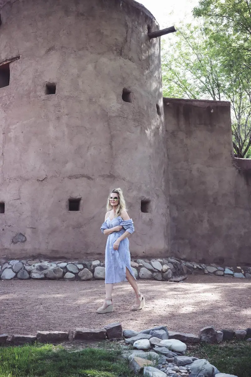 cold shoulder trend, exposed shoulder shirt dress by Bardot in blue and white stripes, paired with marc fisher wedges, quay mirrored sunglasses on fashion blogger and youtuber over 40, erin busbee