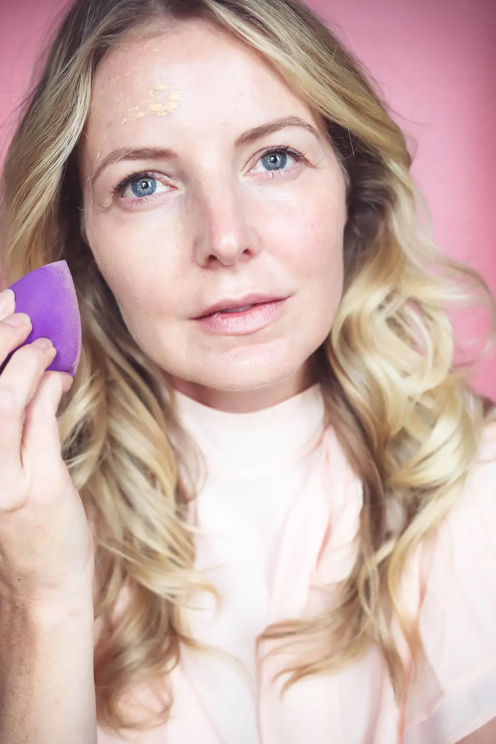 5-Minute Makeup routine, applying magic foundation by Charlotte Tilbury with a sponge