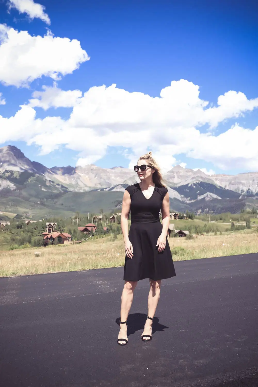 Wear Now, Wear Later, little black dress fit and flare by Eliza J, styling with Dolce Vita studded sandals, on fashion blogger Erin Busbee, over 40, in telluride, colorado