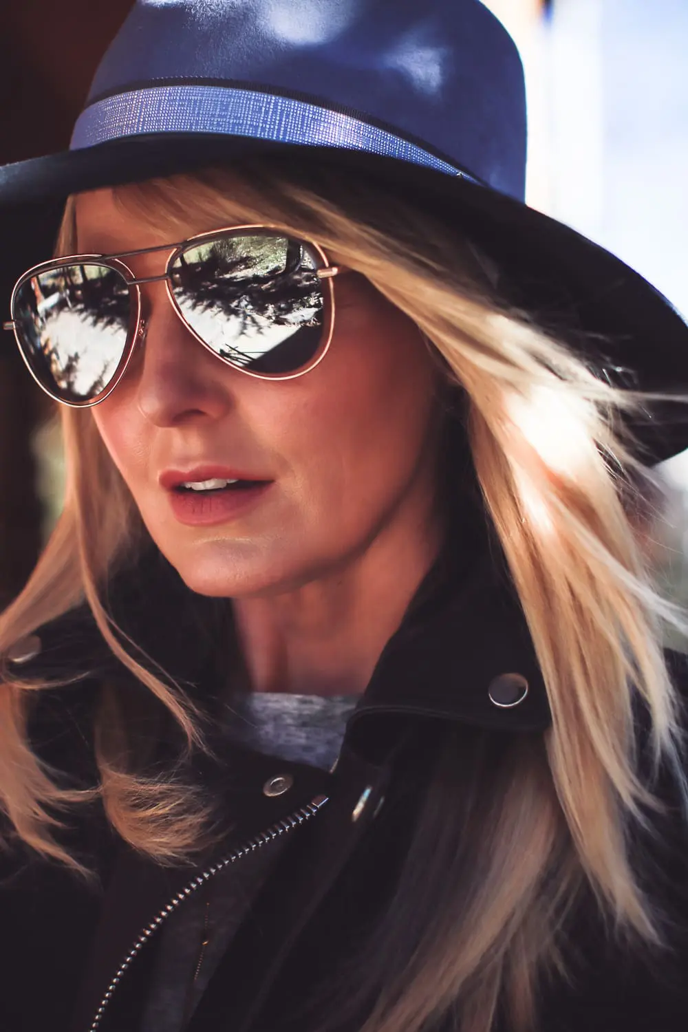 How to style a hat in the fall and winter for women, featuring accessories from Henri Bendel like this felt hat, aviator sunglasses, adjustible lariat necklace and black leather gloves, along with a gold bangle bracelet