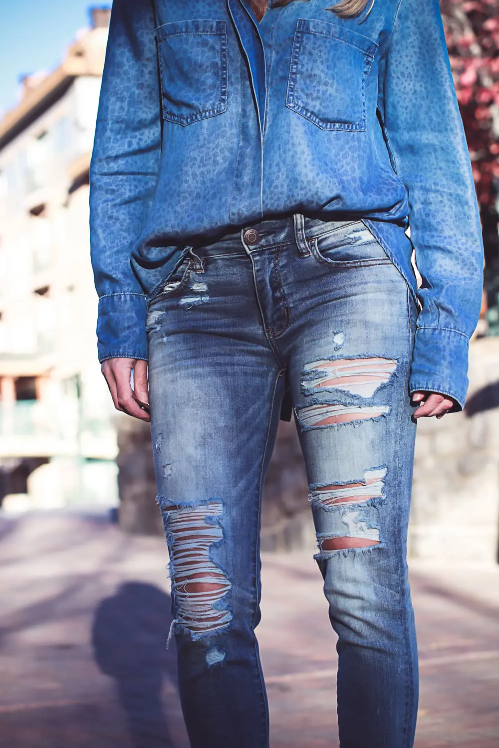 How to wear red boots, red booties by Dolce Vita with denim on denim look, American Eagle jeans, Bella Dahl chambray shirt, on fashion blogger over 40, Erin Busbee of Busbee Style in Mountain Village, Colorado