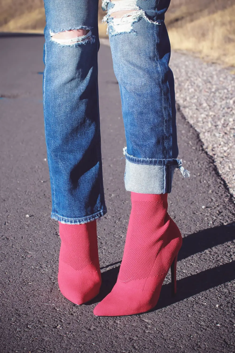 Sock Booties, what are they, how to style sock booties, featuring these red Steve Madden sock booties, Mother dazzler jeans, and a red oversized topshop turtleneck sweater on fashion blogger over 40, Erin Busbee of Busbee Style in Telluride Colorado