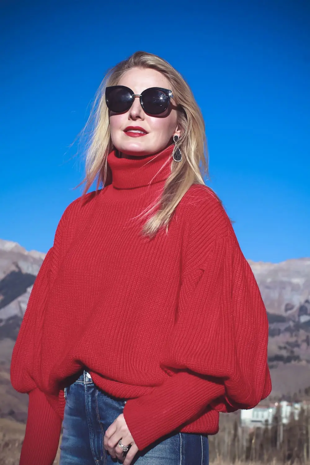 Sock Booties, what are they, how to style sock booties, featuring these red Steve Madden sock booties, Mother dazzler jeans, and a red oversized topshop turtleneck sweater on fashion blogger over 40, Erin Busbee of Busbee Style in Telluride Colorado