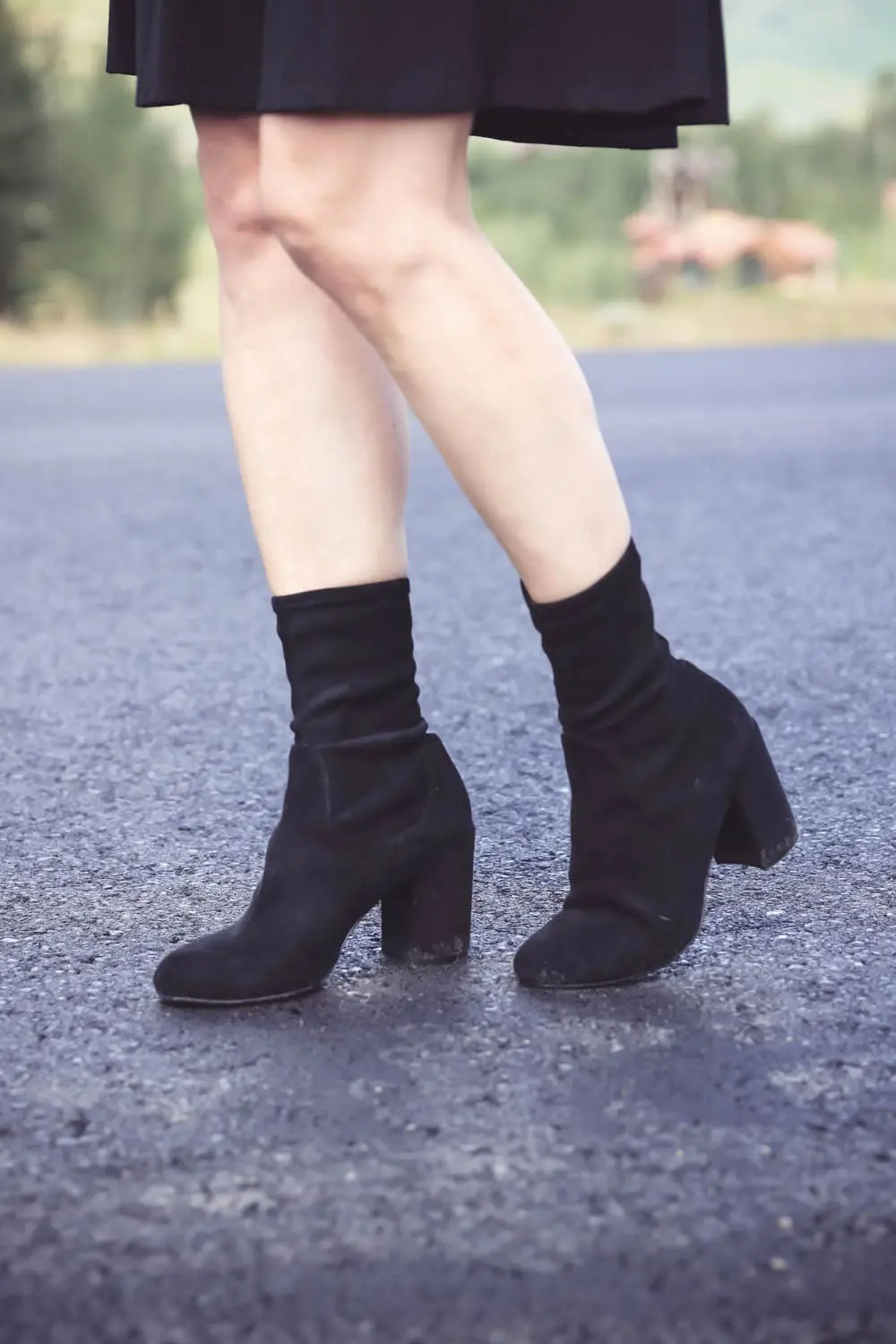 Sock Booties, what are they, how to style sock booties, featuring these black halogen sock booties, paired with Eliza J ponte knit fit and flare dress, joie black leather moto jacket, salvatore ferragamo reversible belt on fashion blogger over 40, Erin Busbee of Busbee Style in Telluride, Colorado