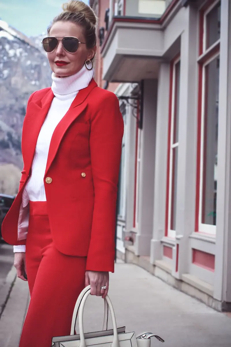 How to wear red from head to toe featuring fashion blogger over 40, Erin Busbee of Busbee Style in Telluride, Colorado wearing a Smythe suit and Steven Madden sock booties