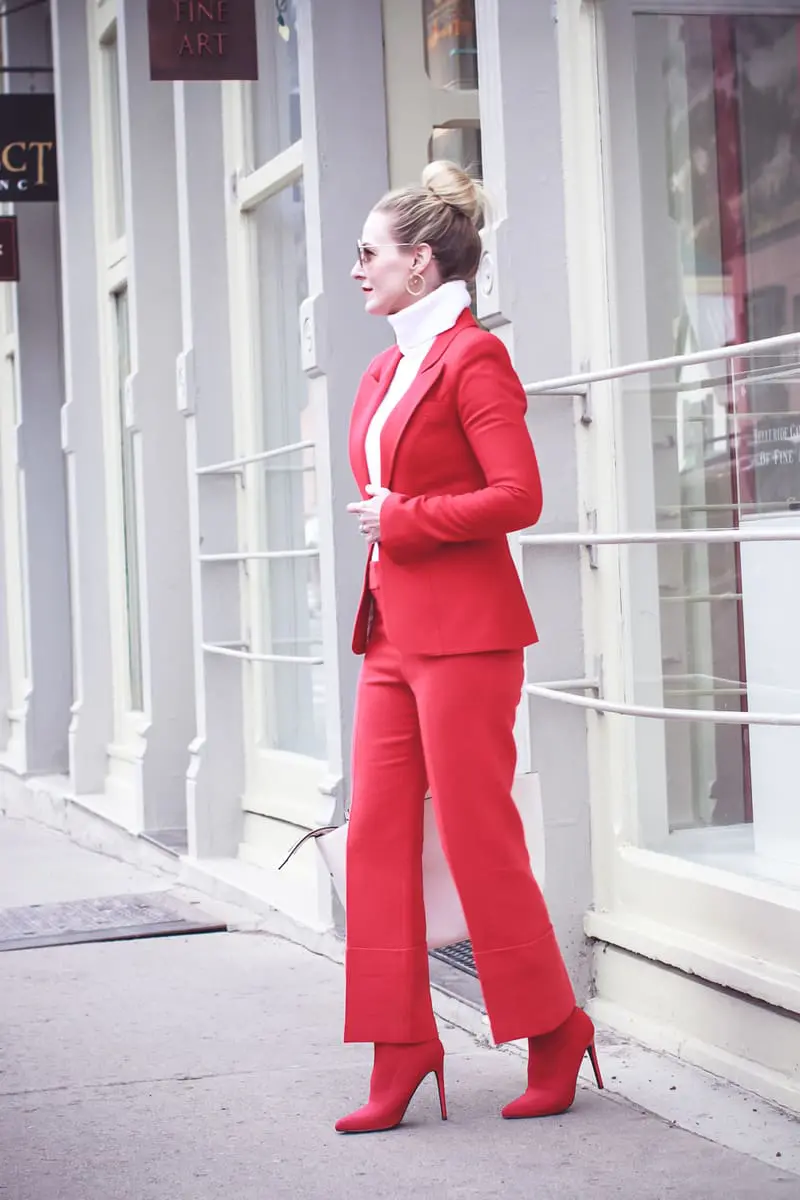 How to wear red from head to toe featuring fashion blogger over 40, Erin Busbee of Busbee Style in Telluride, Colorado wearing a Smythe suit and Steven Madden sock booties