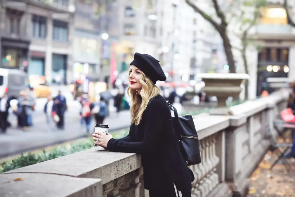 Beret, how to style a beret, how to look french, Erin Busbee of Busbee Style, fashion blogger over 40, walking in NYC with her black beret and all black look including Mother striped jeans, vince camuto patent booties and aqua cashmere choker sweater
