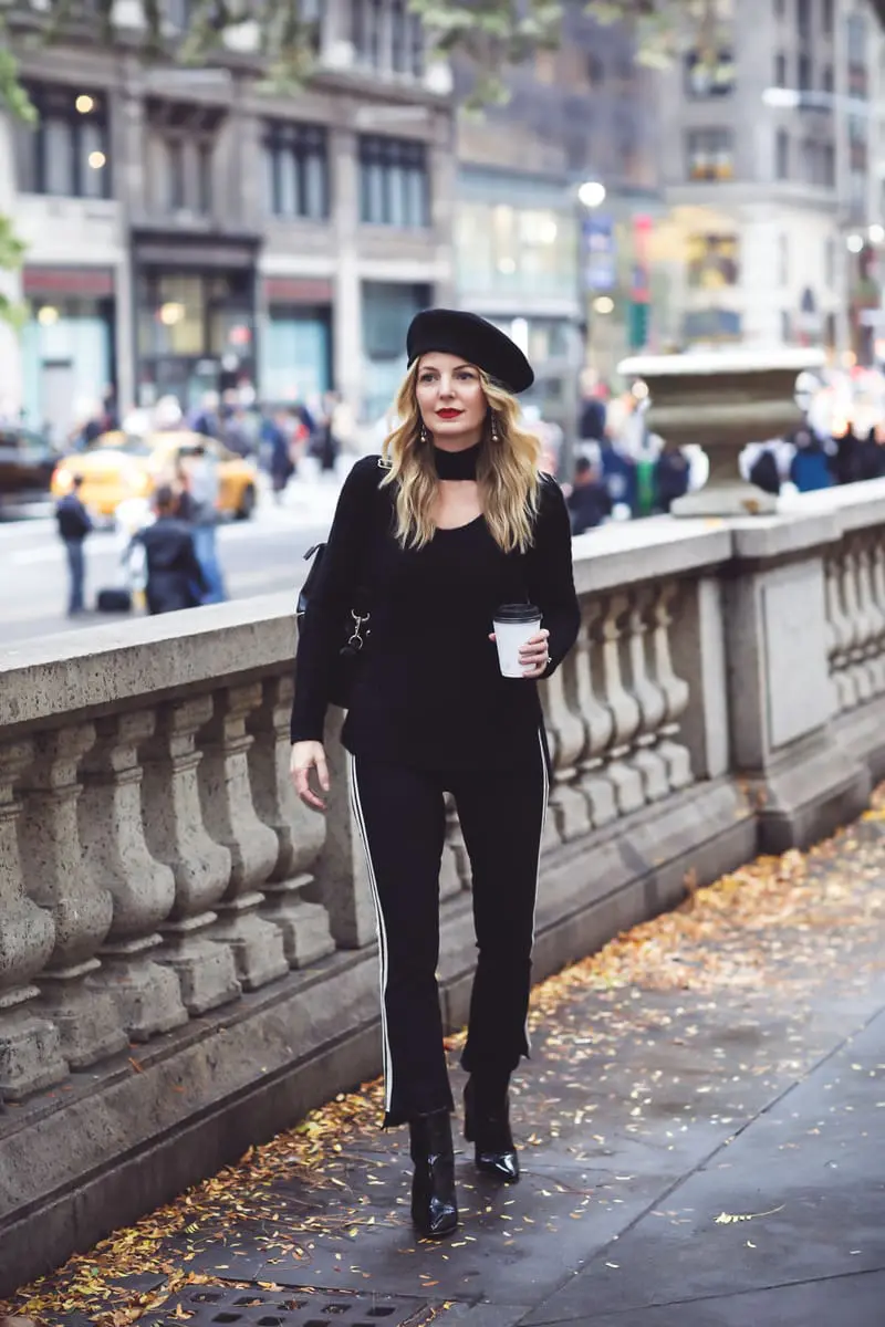 Beret, how to style a beret, how to look french, Erin Busbee of Busbee Style, fashion blogger over 40, walking in NYC with her black beret and all black look including Mother striped jeans, vince camuto patent booties and aqua cashmere choker sweater