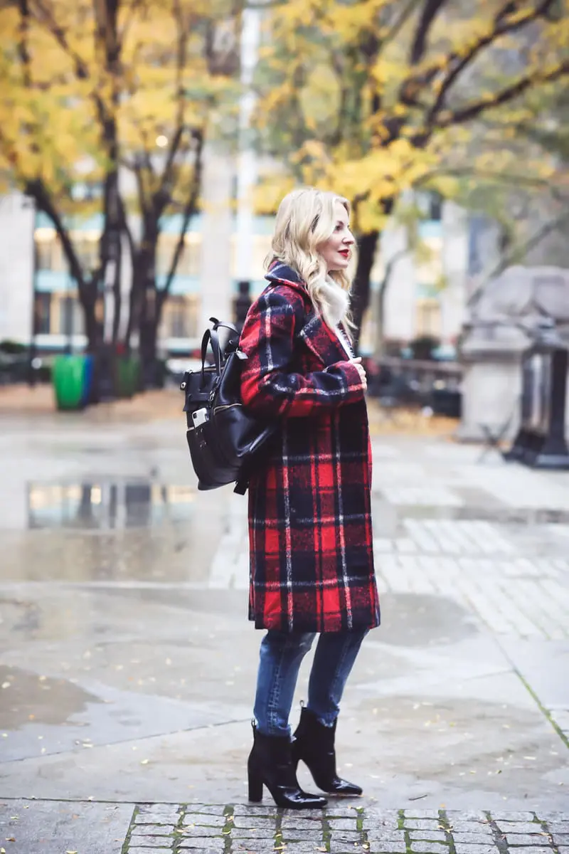 Plaid coat by cupcakes and cashmere in red and navy, with Moussy Jeans, fuzzy white sweater from Bloomingdales, and black patent britsy boots on fashion blogger, Erin Busbee from Busbee Style by NYC public library