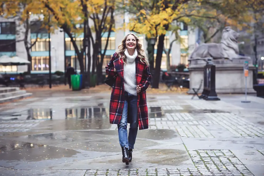 Plaid coat by cupcakes and cashmere in red and navy, with Moussy Jeans, fuzzy white sweater from Bloomingdales, and black patent britsy boots on fashion blogger, Erin Busbee from Busbee Style by NYC public library