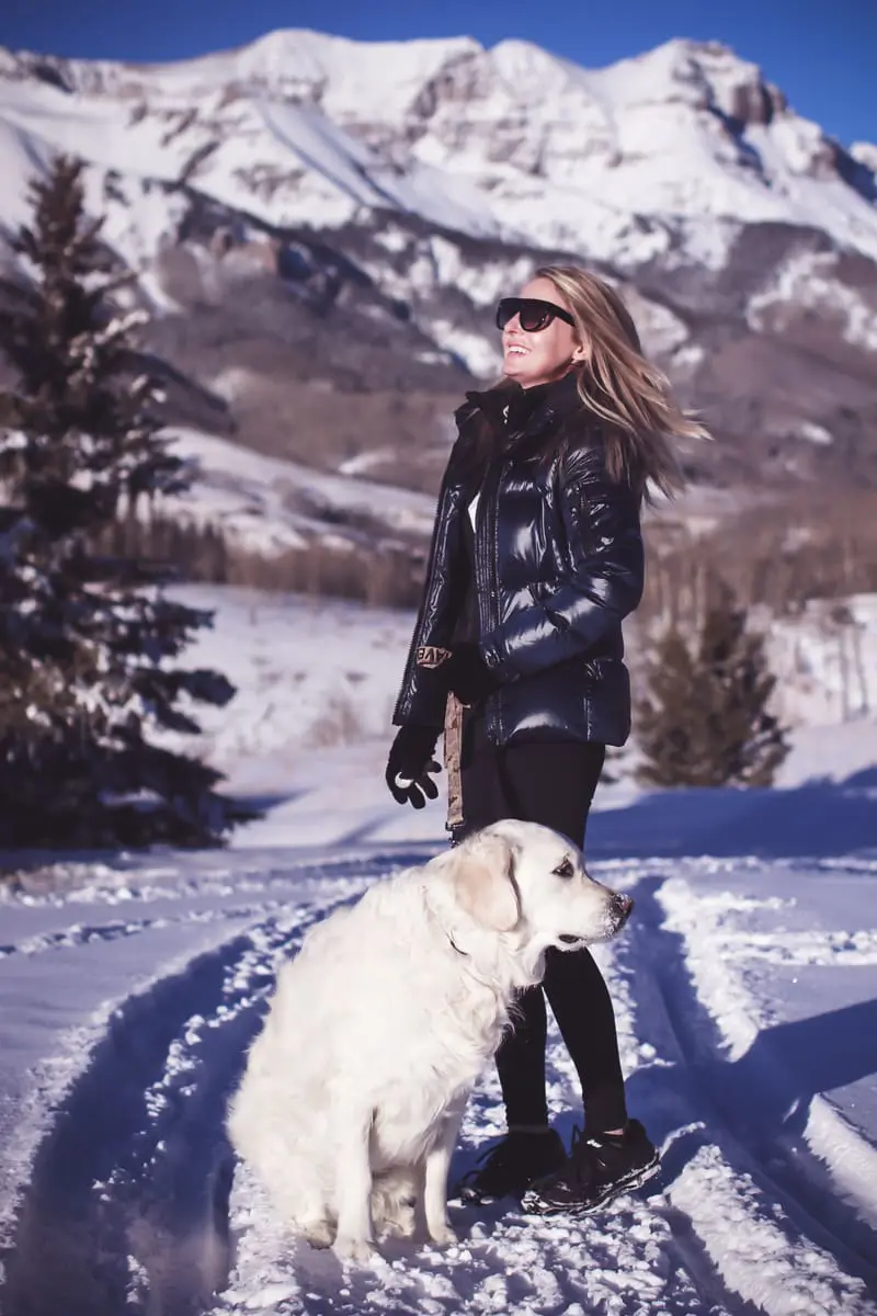 Fitness routine update, featuring activewear from eBay, SAM. New York puffer in midnight blue, black workout vest, white fleece pullover by Northface, and Zella tank on fashion blogger over 40, Erin Busbee, walking her dog, English golden retriever