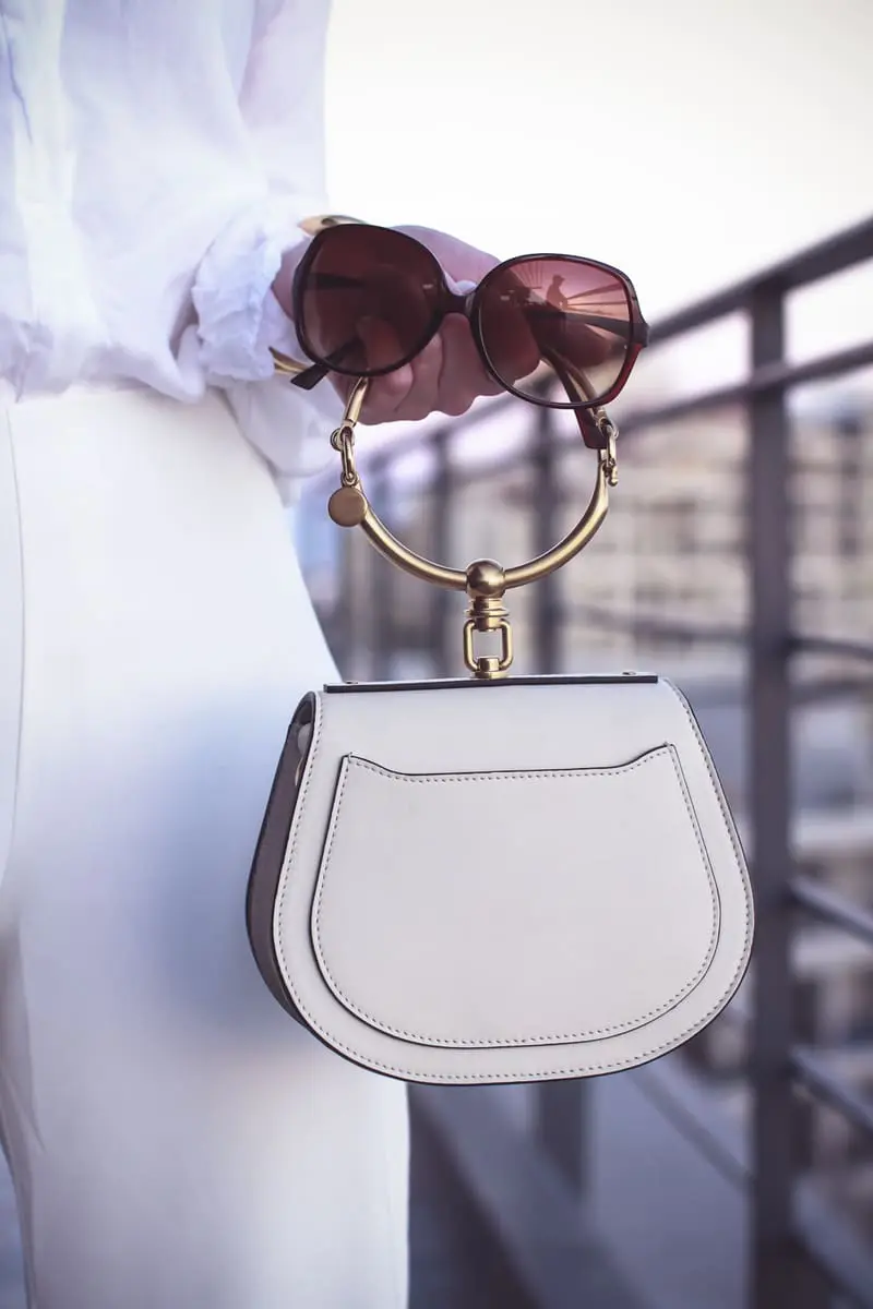 Beach picks, high slit, wide leg white pants by Lovers + friends, with Chloe nile bag in white, on fashion blogger Erin Busbee of BusbeeStyle.com