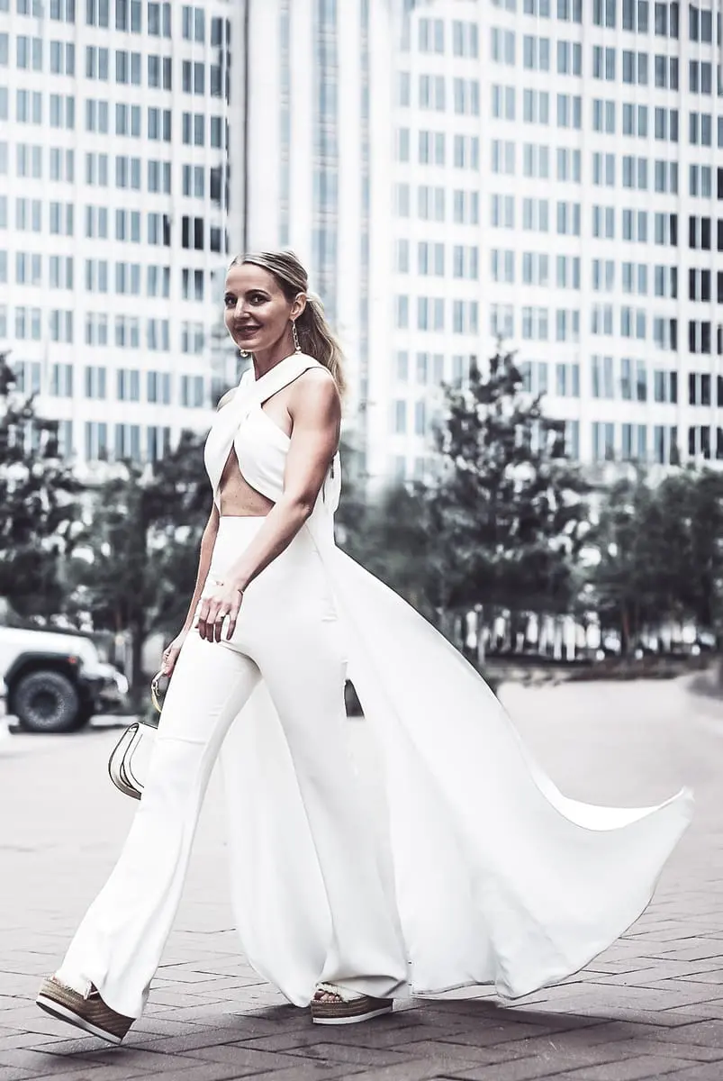 reward style blogger conference 2018 featuring blond woman with hair in pony tail wearing cross front side panel draped top from Asos by Peace and Love paired with Michael Costello white pants for Revolve with See by Chloe wedges and Chloe nile bag in white