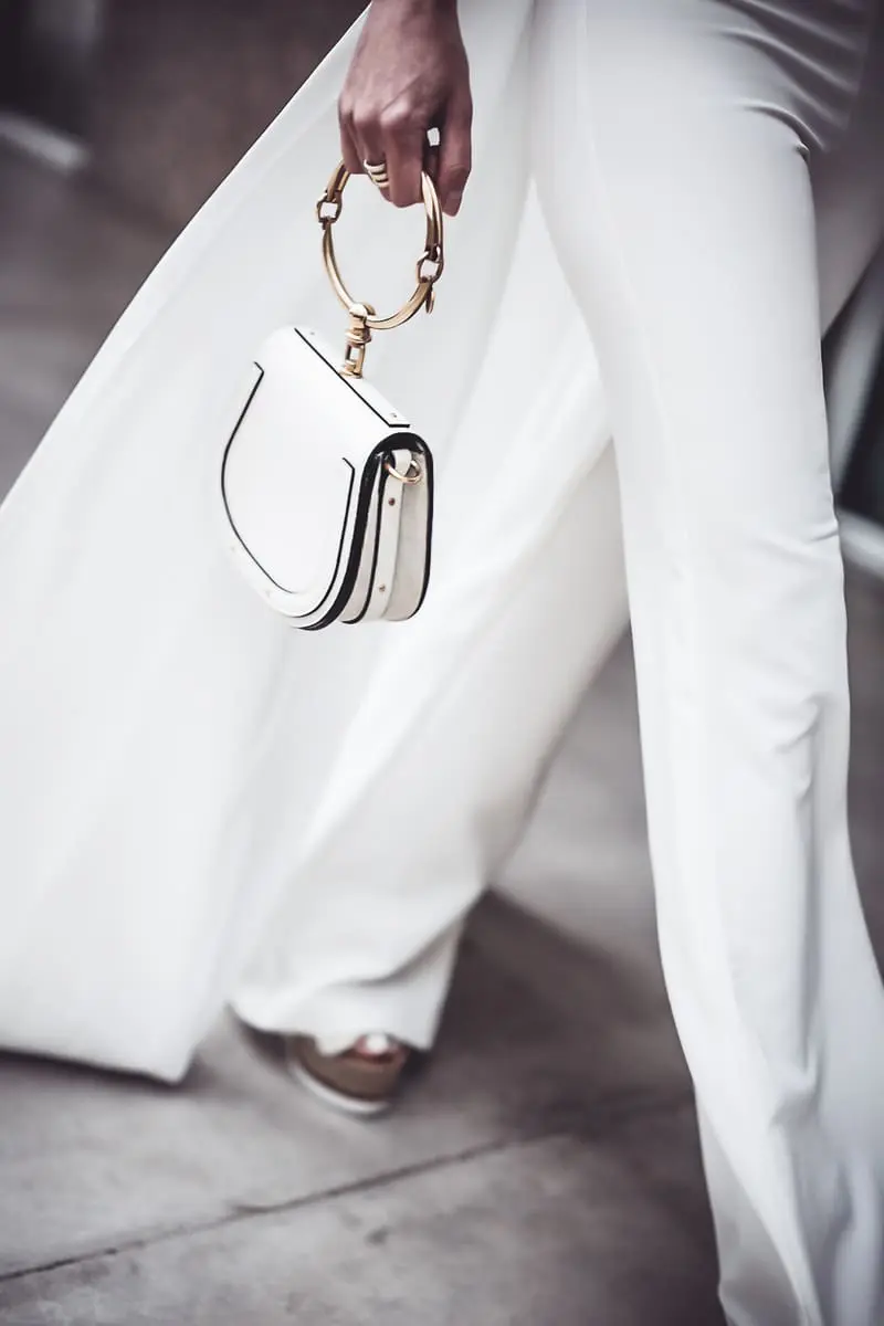 reward style blogger conference 2018 featuring blond woman with hair in pony tail wearing cross front side panel draped top from Asos by Peace and Love paired with Michael Costello white pants for Revolve with See by Chloe wedges and Chloe nile bag in white