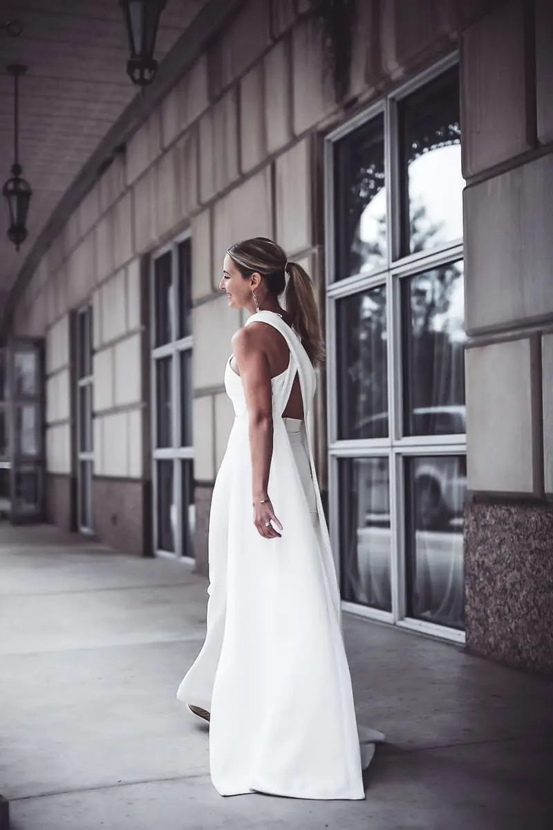 reward style blogger conference 2018 featuring blond woman with hair in pony tail wearing cross front side panel draped top from Asos by Peace and Love paired with Michael Costello white pants for Revolve with See by Chloe wedges and Chloe nile bag in white