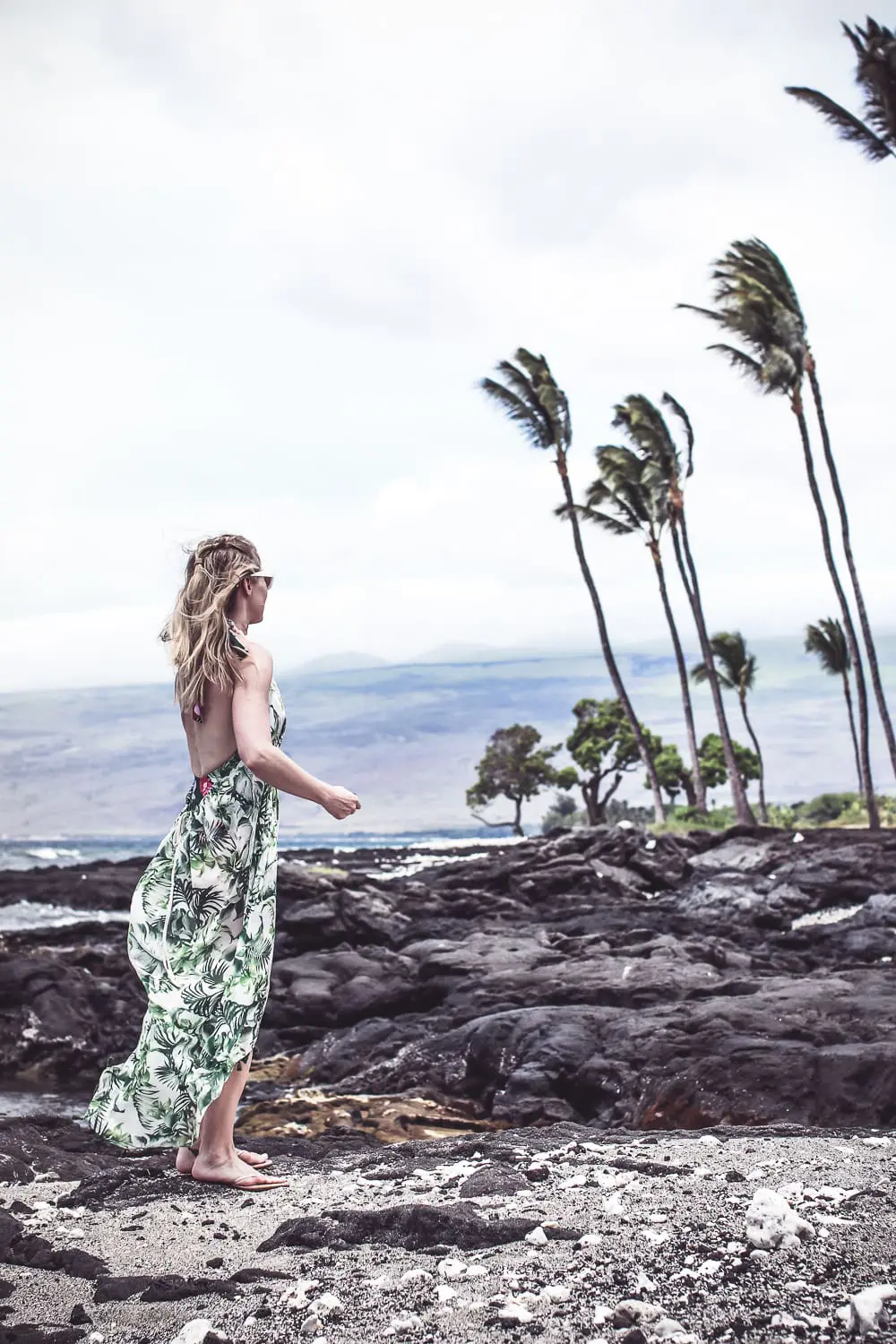 Palm prints fashion trend 2018, blond woman wearing palm print cover up on the beach in Hawaii on the Big Island