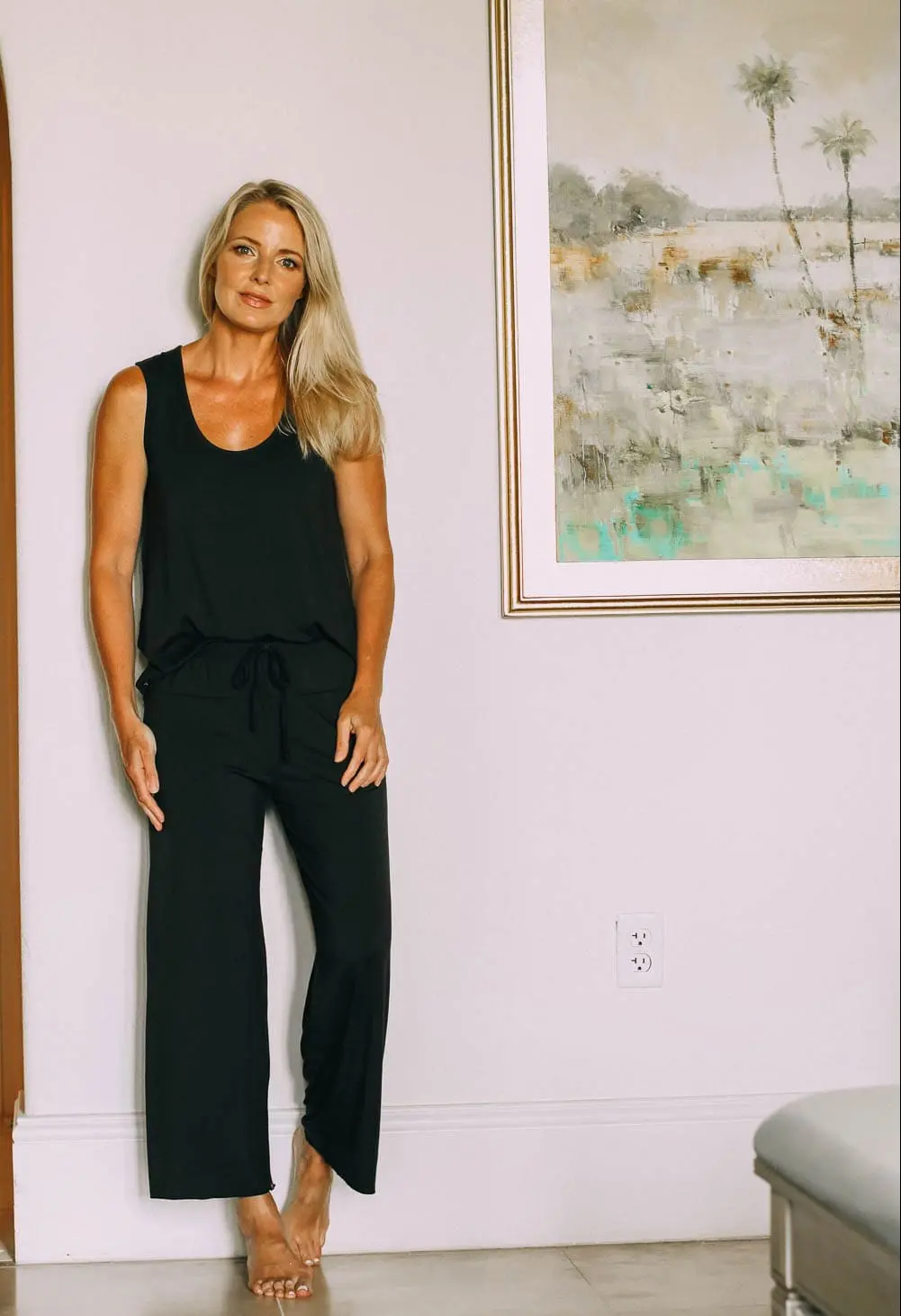 best pajamas, black luxe jersey sleeveless top and cropped pants pajamas set by Barefoot Dreams on blonde woman
